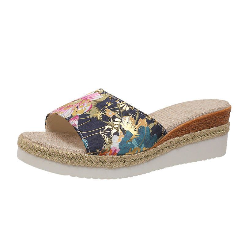 Floral wedge sandal with woven sole on a white background