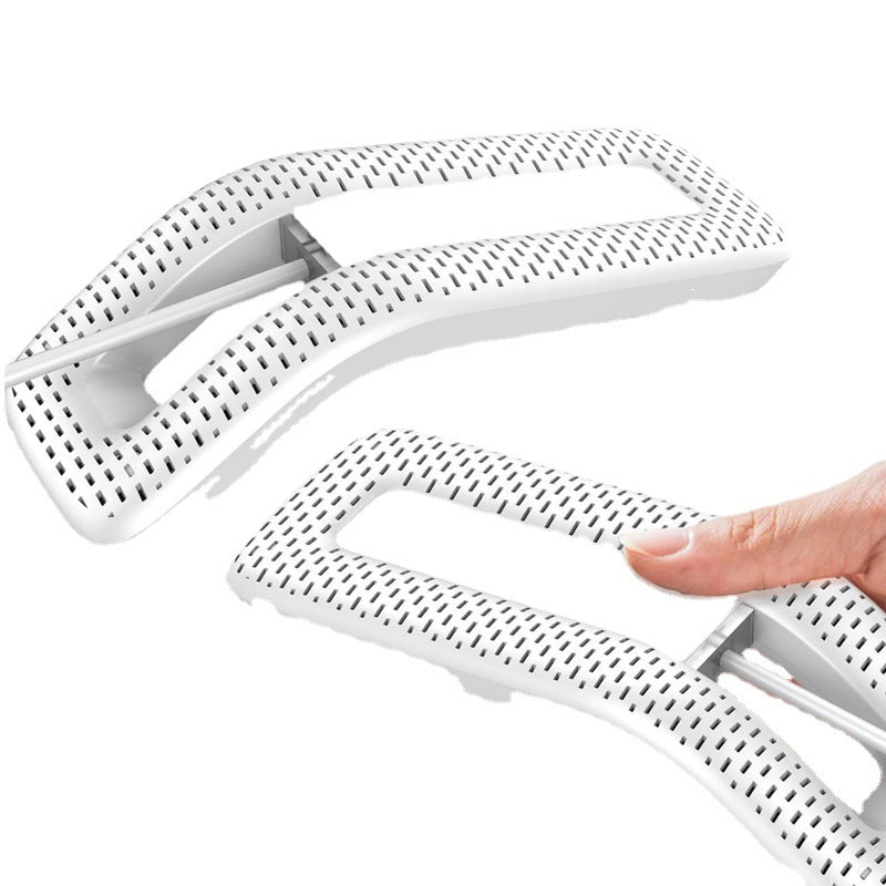 White plastic shaper with a hand holding one of them on a white background