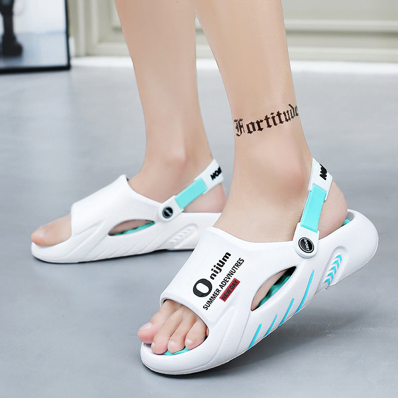 White sandals with blue accents worn by a person on a neutral background