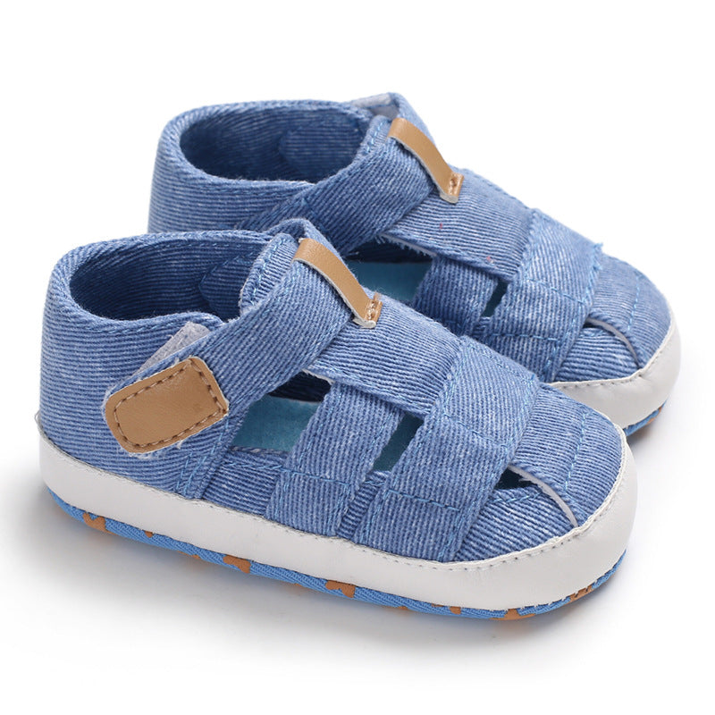 Pair of blue children's sandals with brown straps on a white background