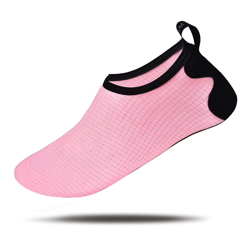 Pink water shoe with black top on a white background