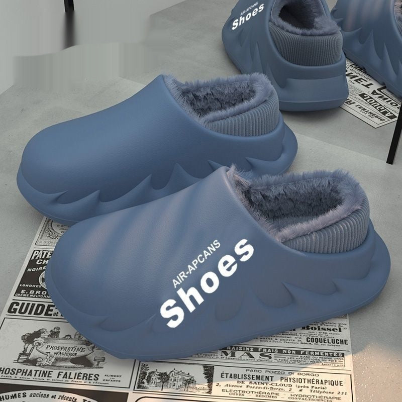 Blue slippers with fluffy interior on a surface with old newspaper.