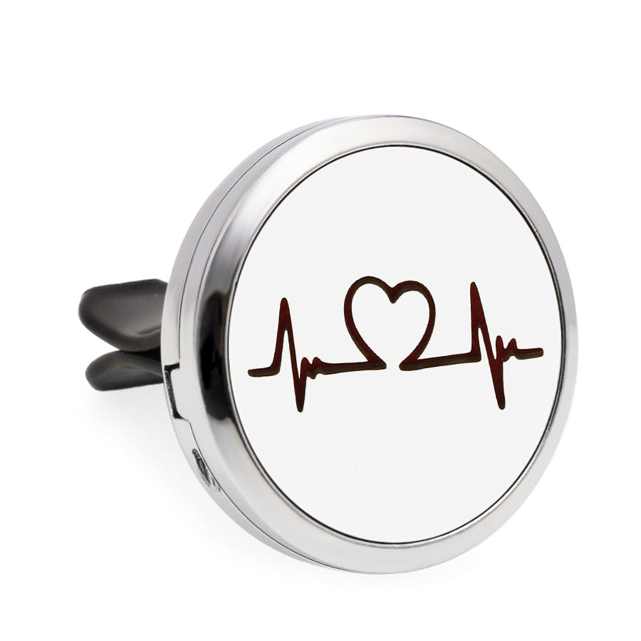 Round metallic object with heart and pulse line design on a white background