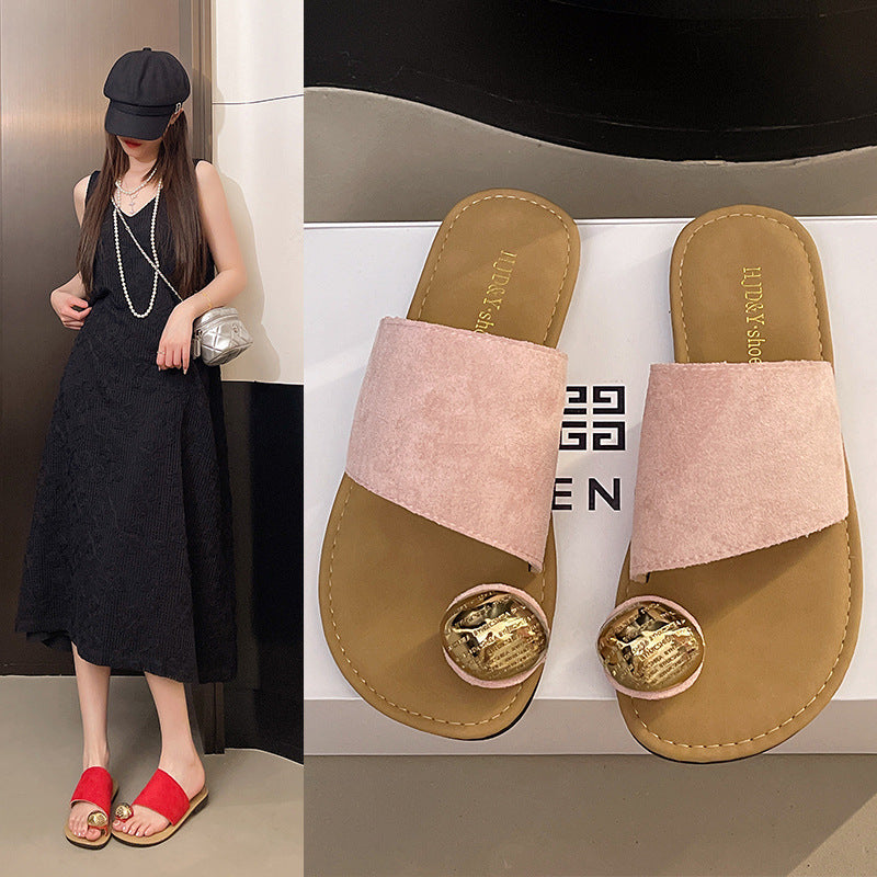 Woman wearing a black dress and red sandals with a close-up of brown sandals with pink straps and gold accents.