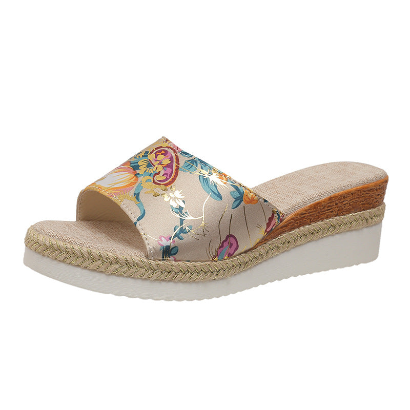Floral wedge sandal with woven sole on a white background