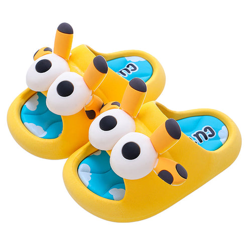 Pair of yellow cartoon slippers with black and white accents on a white background