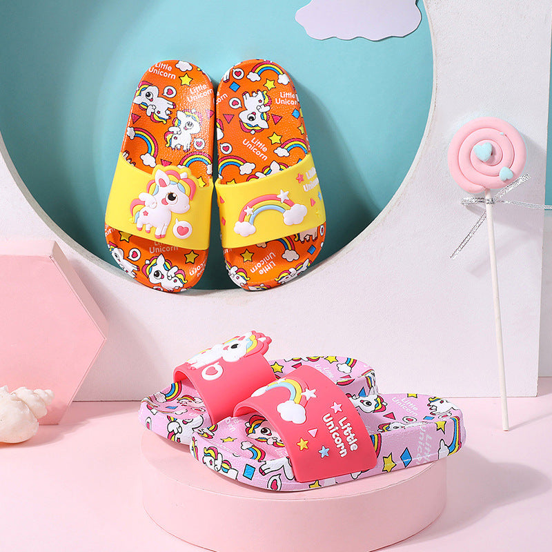 Colorful children's sandals with unicorn and rainbow designs on a pink and blue background.