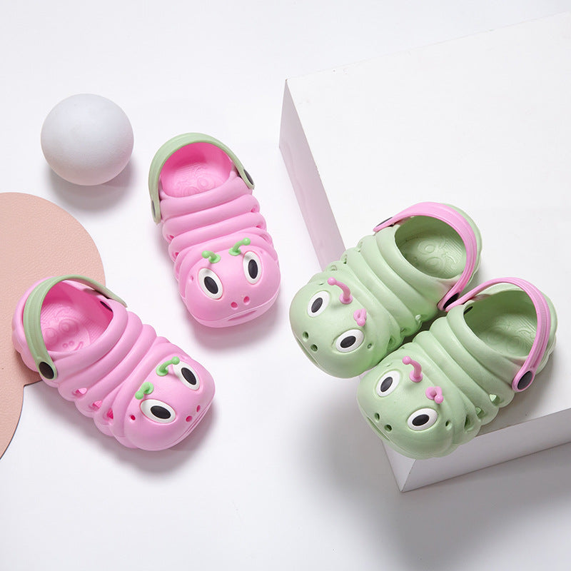 Pink and green children's sandals with caterpillar design on a white background
