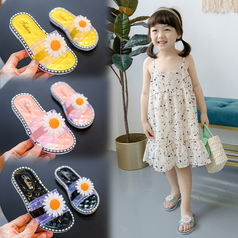 Children's sandals with floral design held by hands, and a child wearing them indoors.