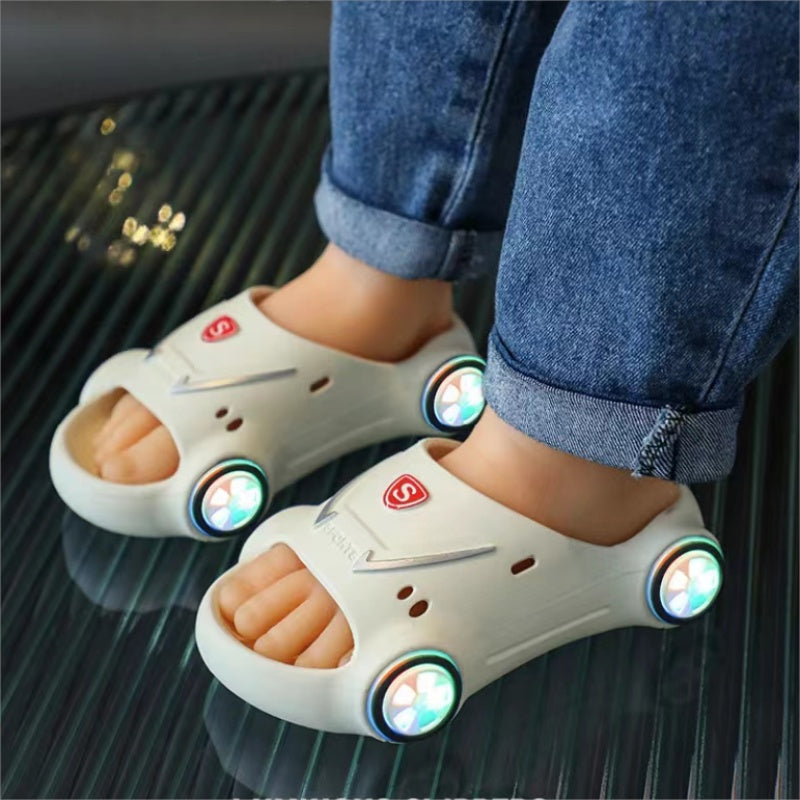 Children's white sandals with colorful lights on a reflective surface