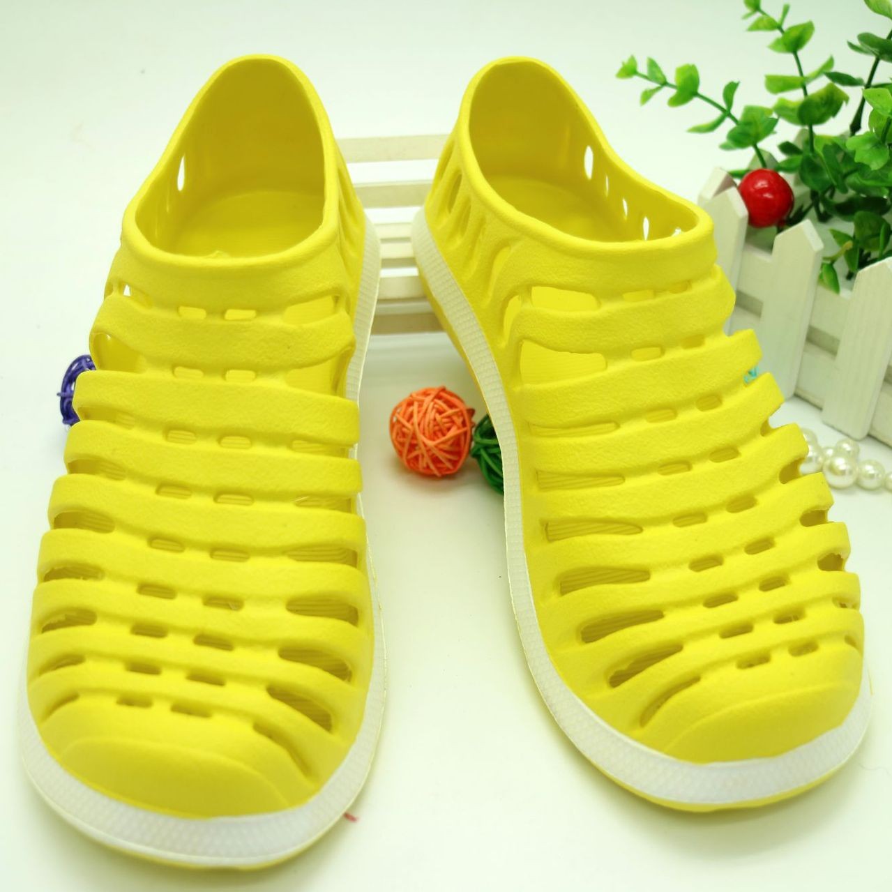 Yellow sandals with white soles on a white background
