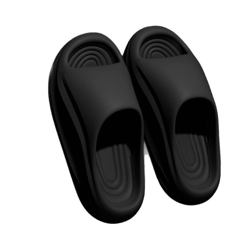 Pair of black slippers on a white background