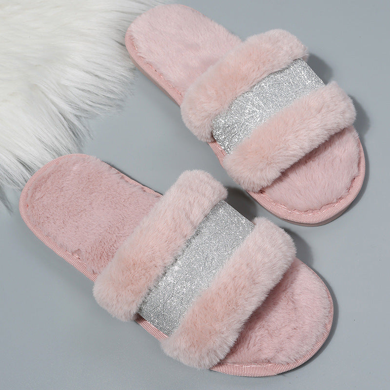 Pink slippers with fluffy texture and silver glittery band on a gray background