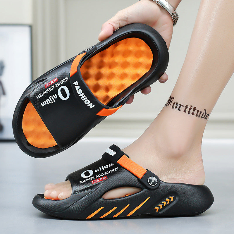 Black and orange sandals with 'Orijun' branding held by a person's foot.