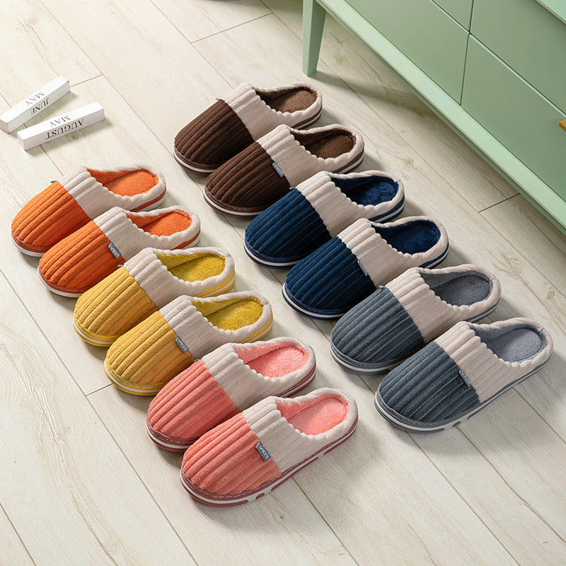 Set of colorful slippers arranged on a wooden floor.