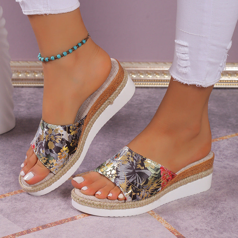 Colorful floral wedge sandals on a neutral background