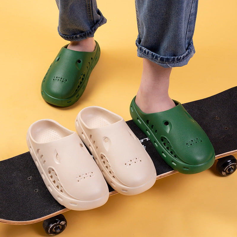 Green and beige clogs on a skateboard with a yellow background
