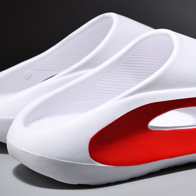 White shoes with a red sole on a gray surface