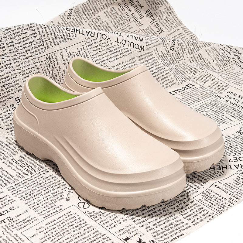 White clogs with green soles on a newspaper background