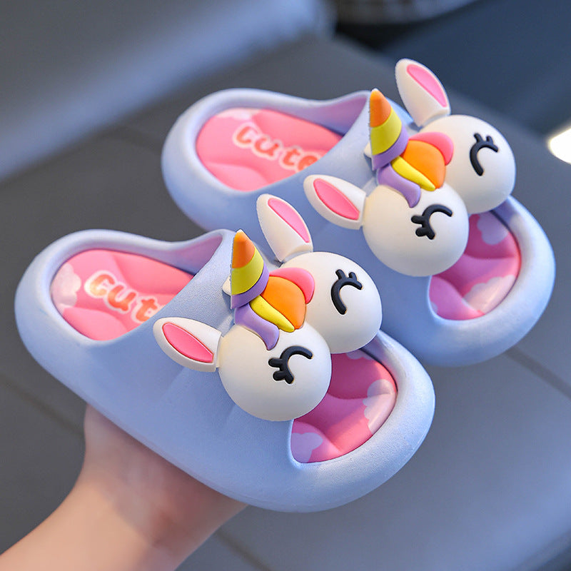 Unicorn-themed children's slippers with pink hearts and 'Cute' text on a neutral background.