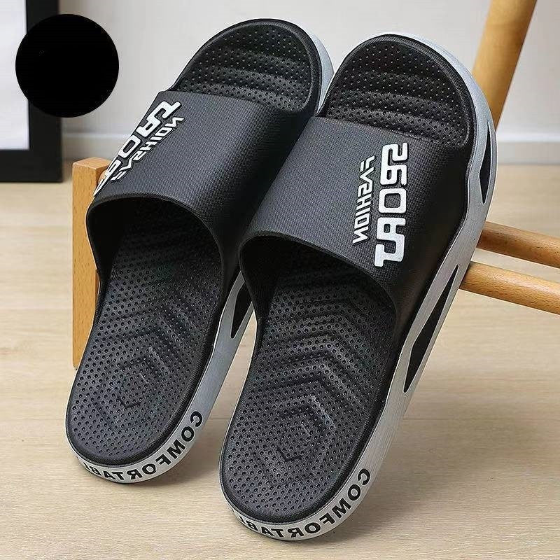 Black slides with brand logo on a wooden surface