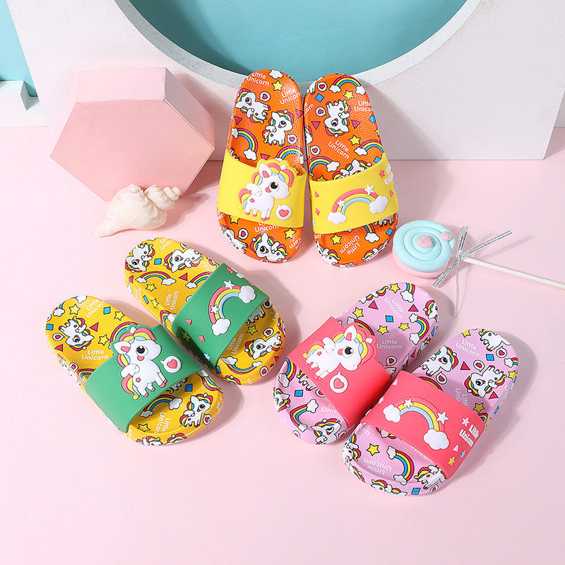 Colorful children's sandals with cartoon designs on a pink background