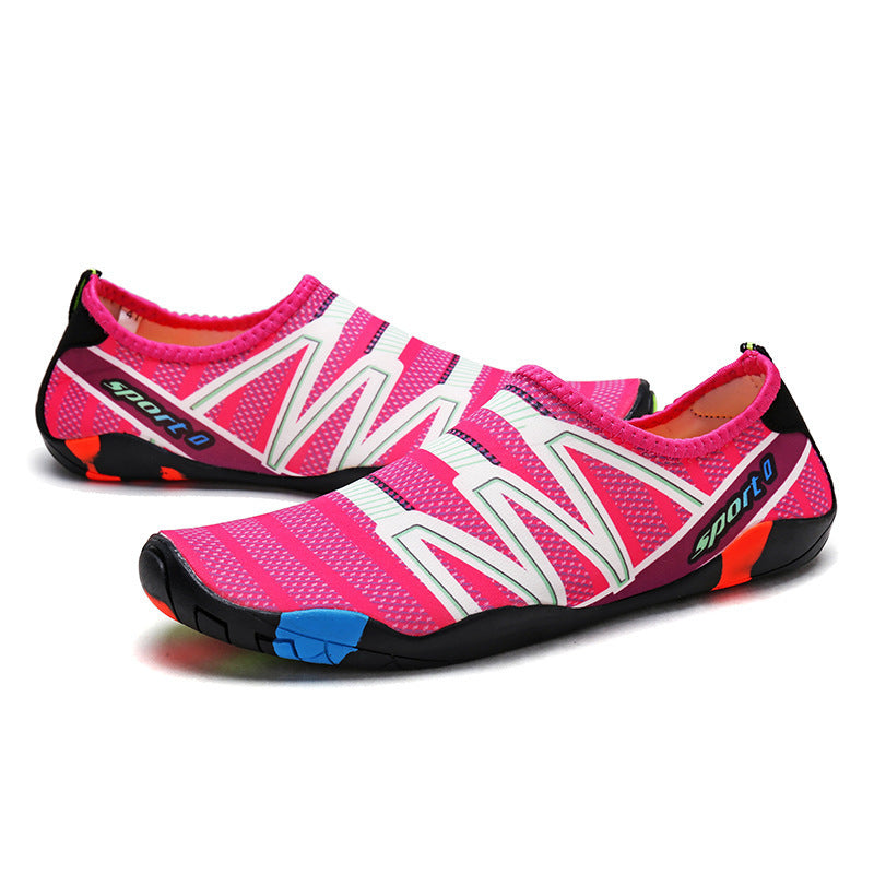 Pink and black water shoes with white accents on a white background