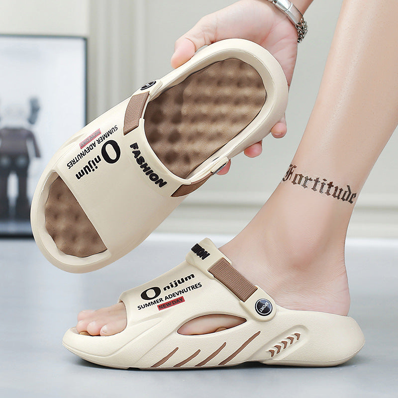 Beige sandals with text held by a hand, on a neutral background