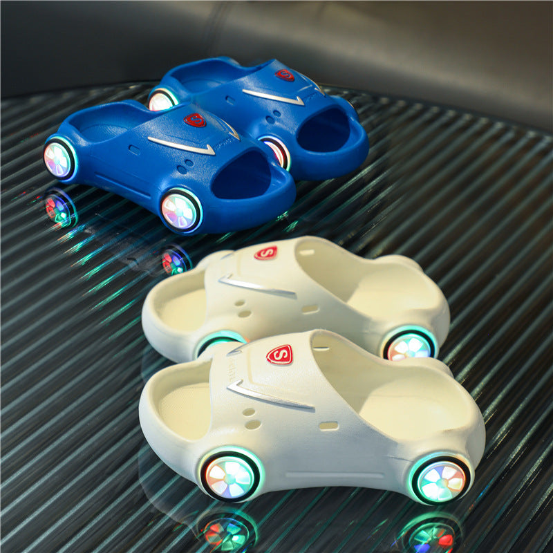 Blue and white slide sandals with glowing wheels on a reflective surface