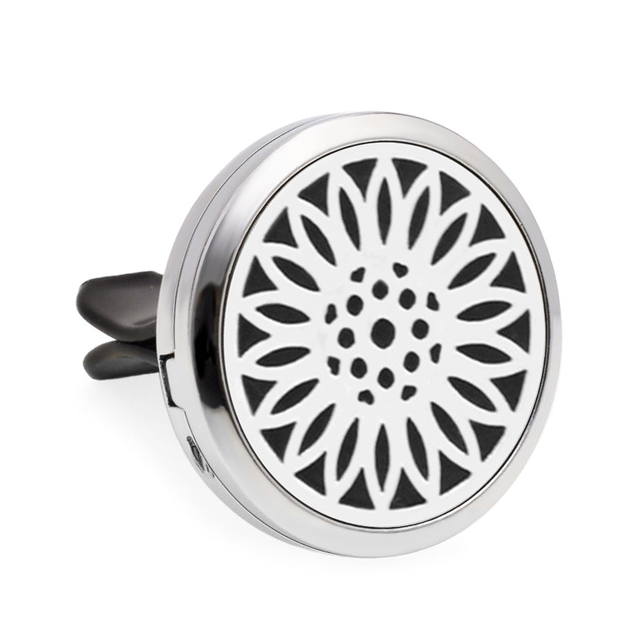 Round metallic diffuser with black floral pattern on a white background