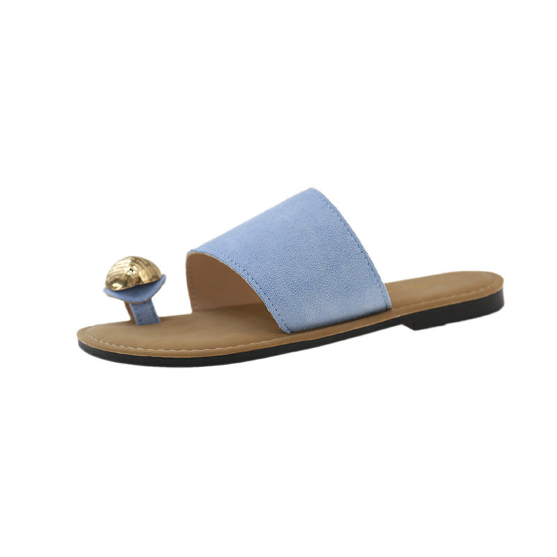 Blue sandal with a gold embellishment on a white background