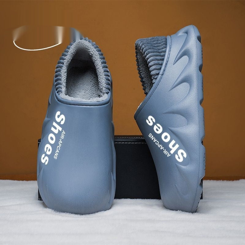 Pair of blue slippers with 'Shoes by Paracan' branding on a brown background