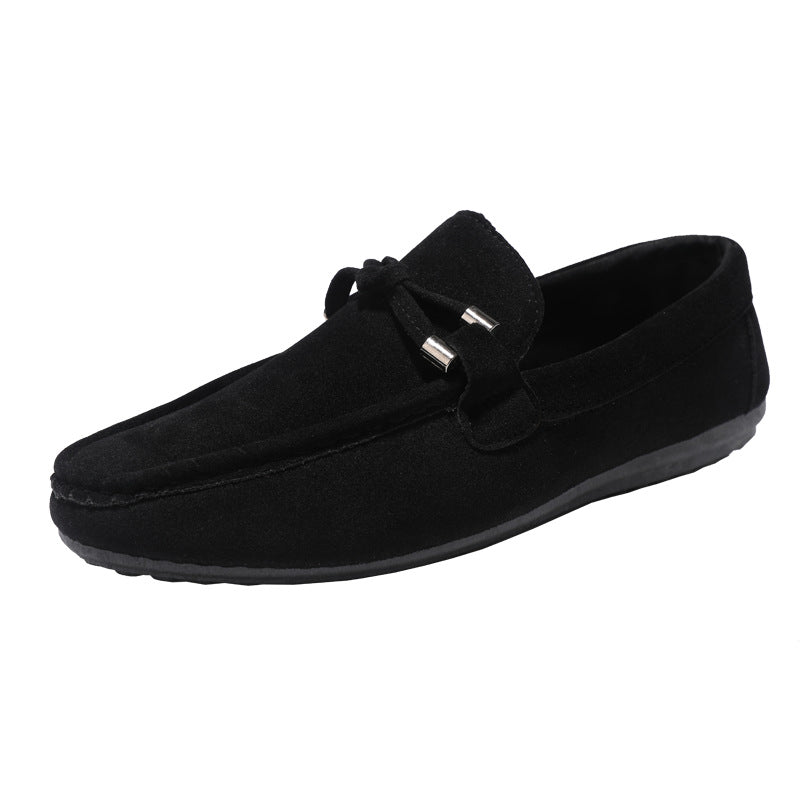 Black suede loafers on a white background