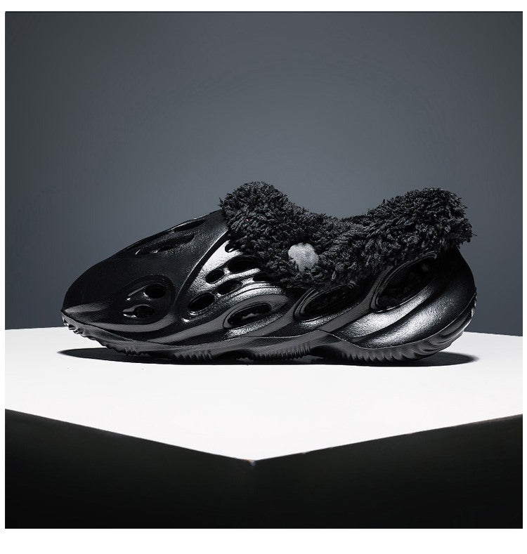 Black sneaker with textured side on a gray background