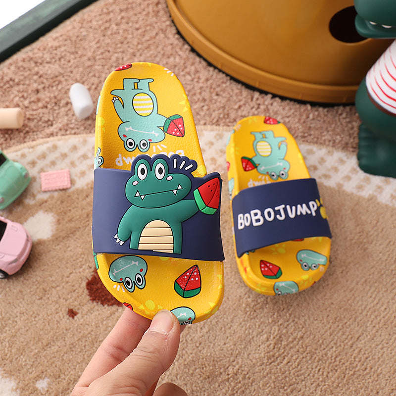 Colorful children's sandals with cartoon designs on a carpeted floor.