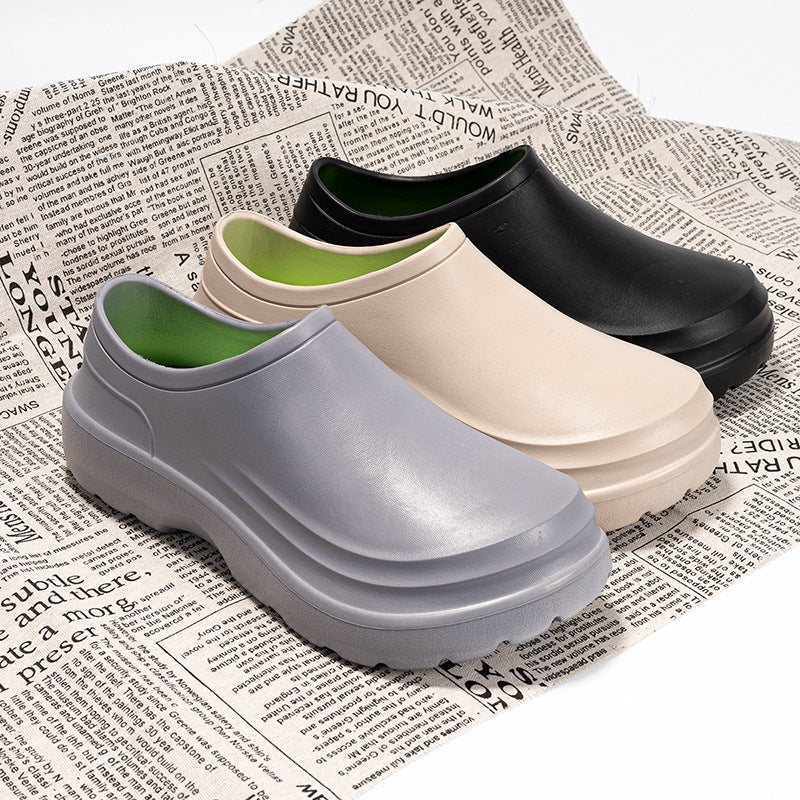 Four pairs of clogs in gray, black, green, and beige on a newspaper background.