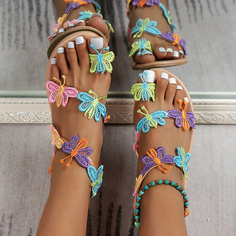 Colorful butterfly sandals on a neutral background