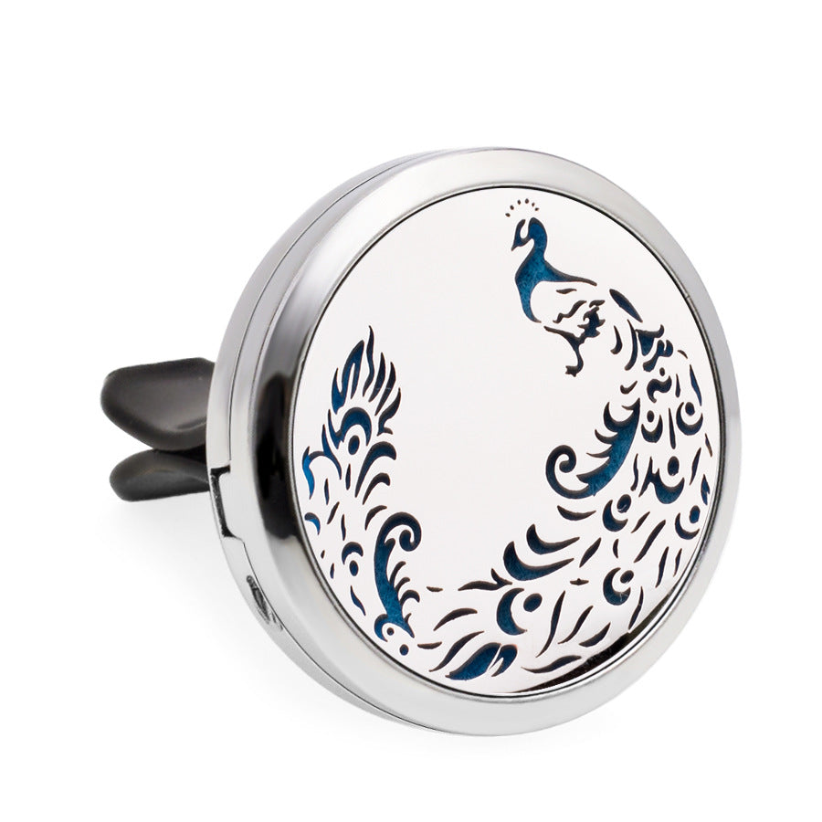 Round silver car air freshener with peacock design on a white background